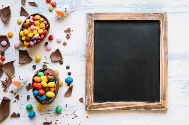 Blackboard near Easter sweets and rabbits