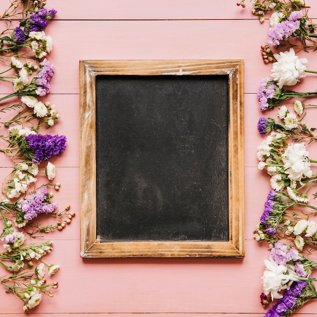 Blackboard and small colorful flowers