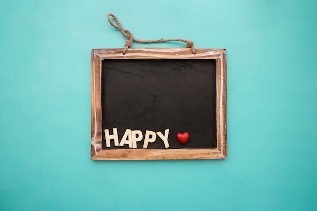 Free photo blackboard with happy lettering and heart