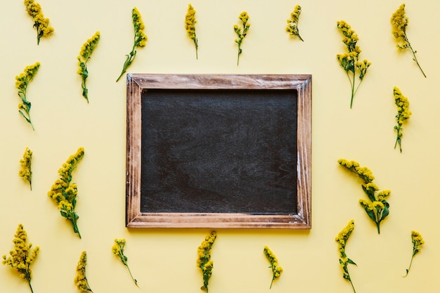 Free photo blackboard in yellow flowers