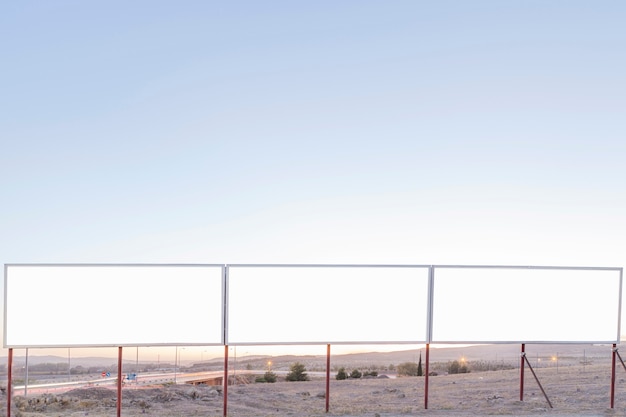 Free photo blank advertising billboards near the highway against blue sky