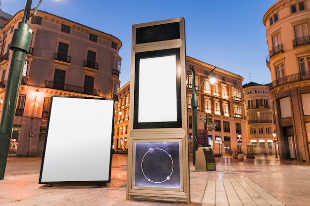 Blank advertising panel in city at night