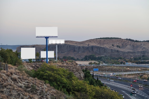 Blank billboards for new advertisement on mountain near the highway