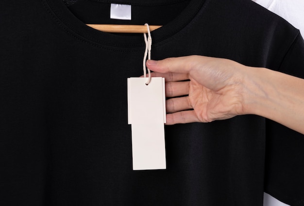 Free Photo blank black t-shirt and blank label tag for advertising.