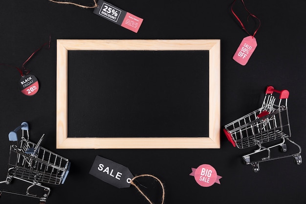 Free Photo blank blackboard with shopping carts on the side