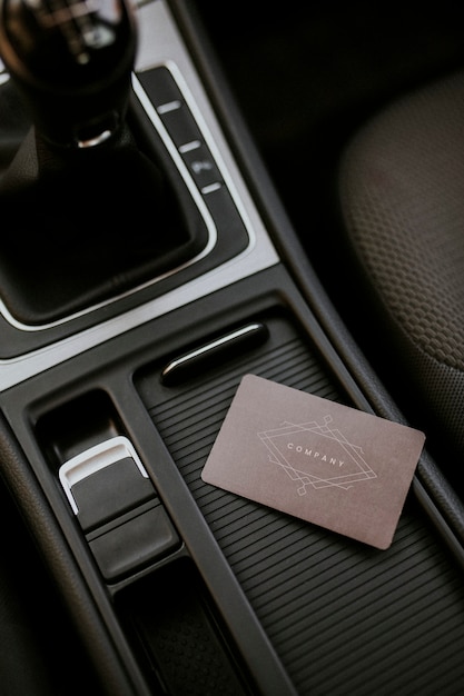 Free photo blank brown business card template on a center of car console space