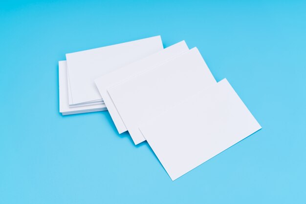 Blank business card on blue background .