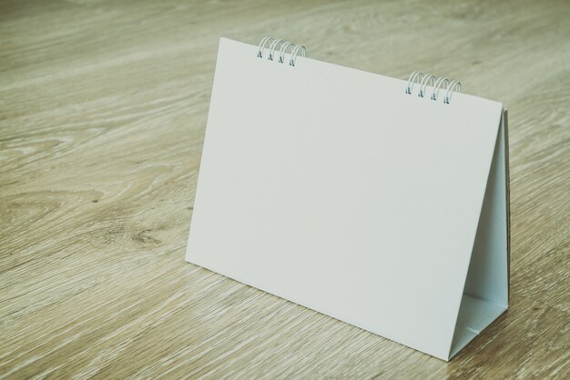 Blank calendar on wooden background