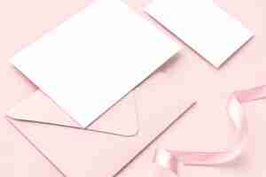 Free photo blank card and envelope on a pink background