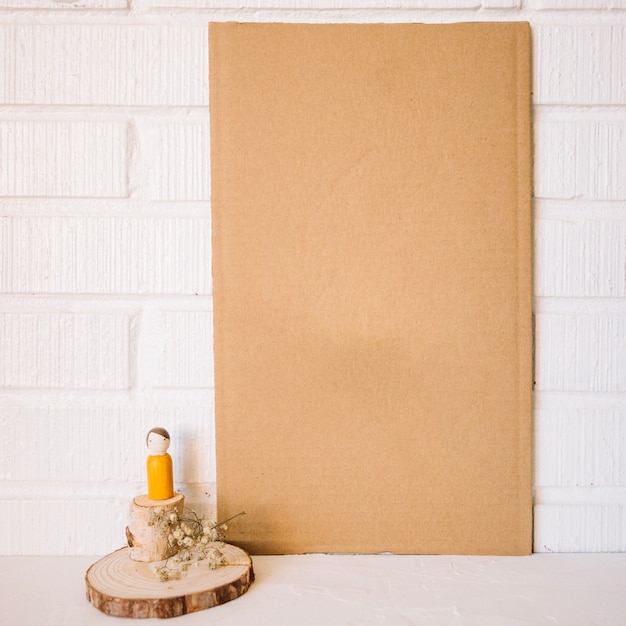 Free photo blank cardboard near toy figure