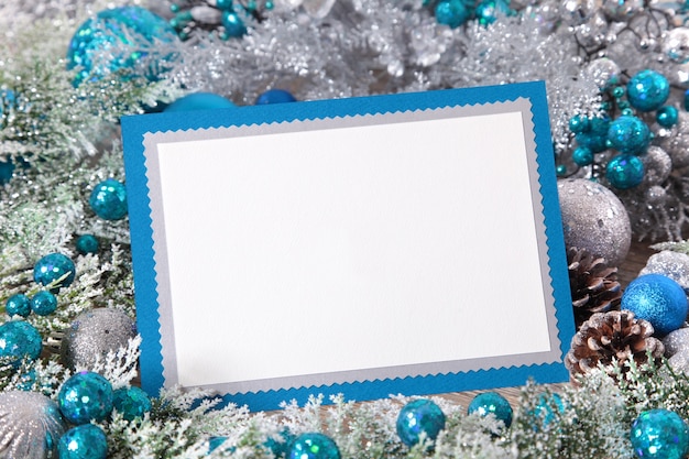 Free photo blank christmas card with silver and blue decoration