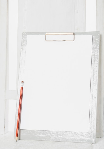 Blank clipboard on wooden chair 