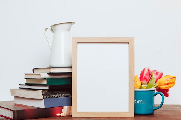 Blank frame between flowers and books