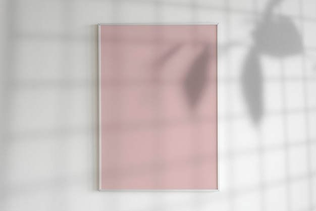 Free Photo blank frame on a wall with plant shadow