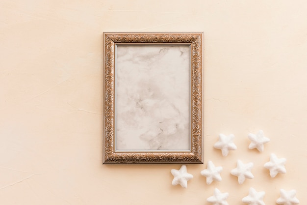 Blank frame with small stars on table