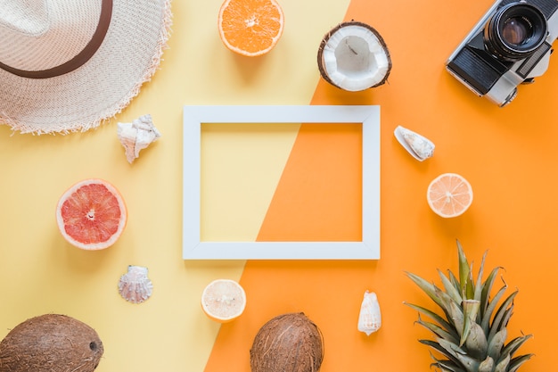 Free Photo blank frame with travel accessories, fruits and shells