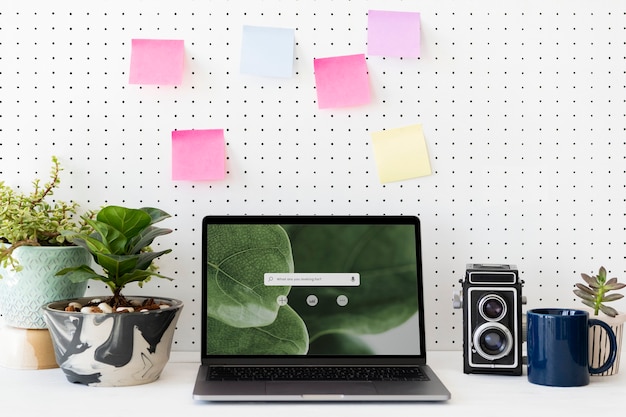 Free Photo blank laptop screen on a green workstation