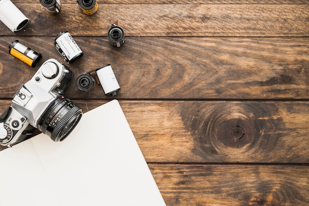 Blank notebook near camera and cartridges