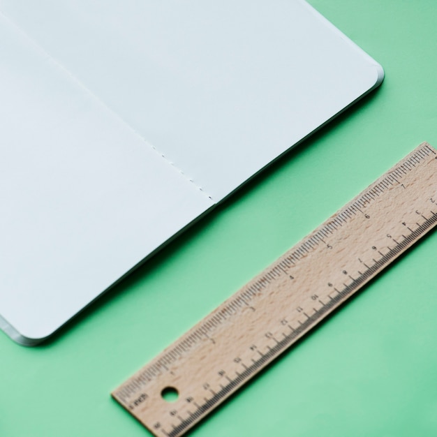 Blank notebook and ruler isolated on background