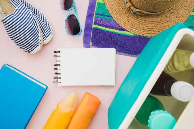 Blank notebook surrounded by summer elements