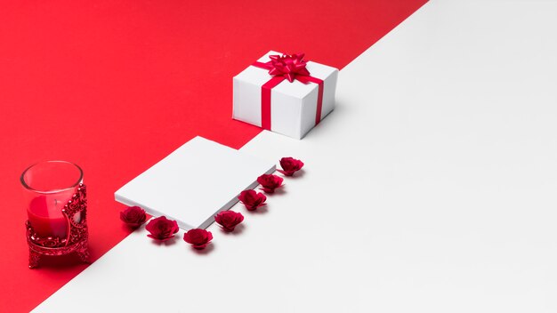 Blank notepad with small roses buds on table