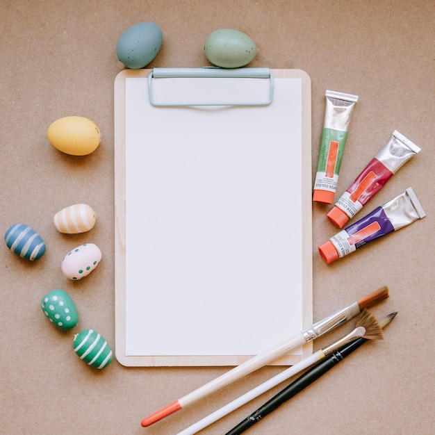 Blank paper and colorful Easter eggs