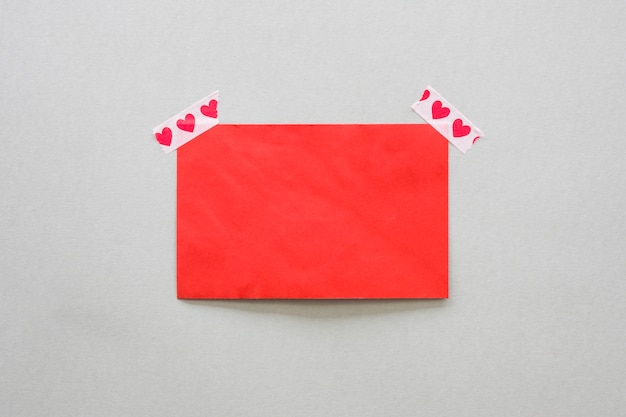 Free photo blank paper fixed with scotch tape with hearts