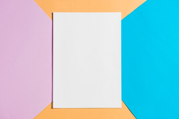 Blank paper sheet on colorful papers backdrop