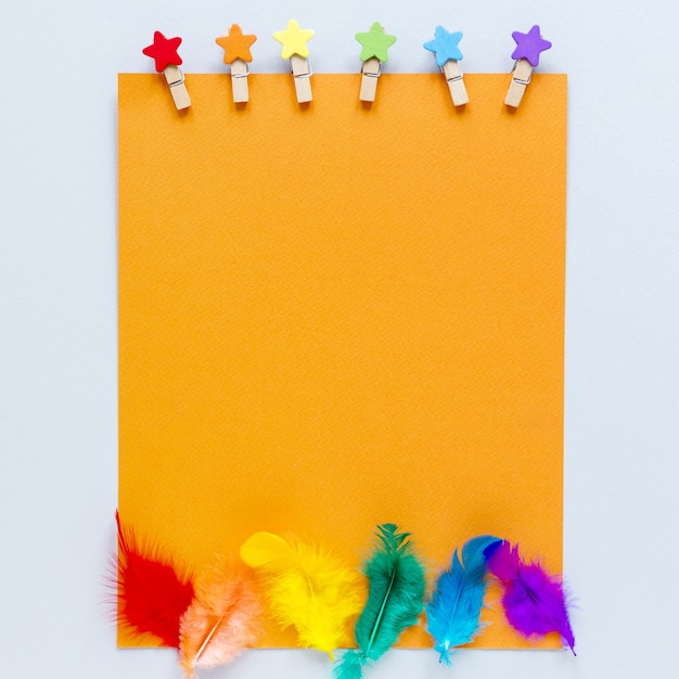 Free photo blank paper sheet with rainbow feathers