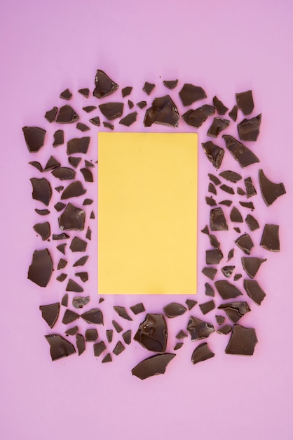 Free Photo blank paper with cracked chocolate on table