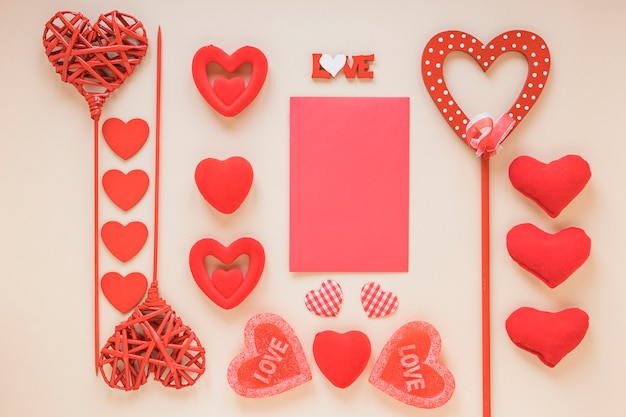 Free photo blank paper with different hearts on light table