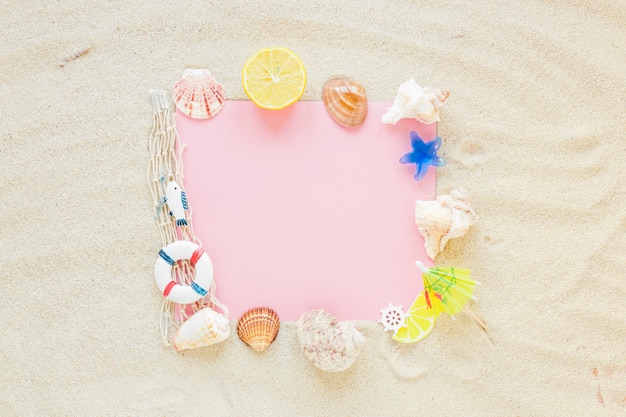 Free photo blank paper with sea shells on sand