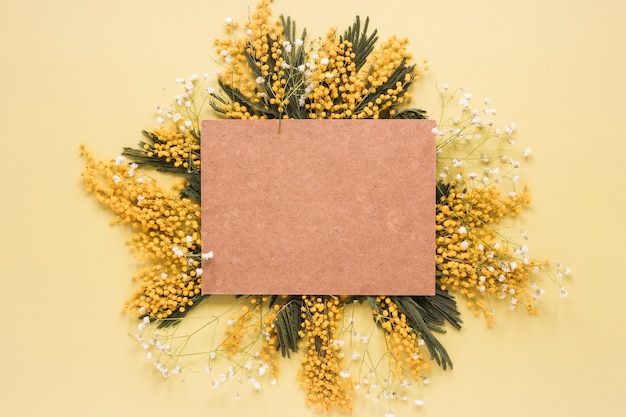 Free photo blank paper on yellow flower branches