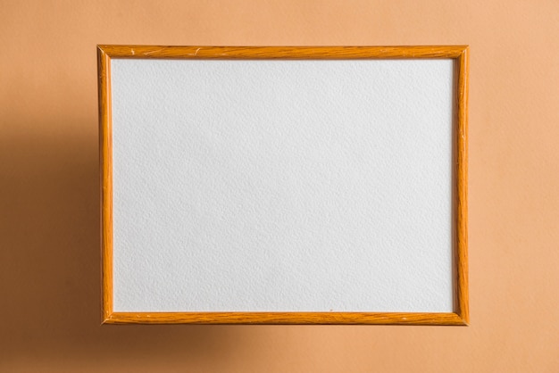 Free photo blank picture frame on colored wall