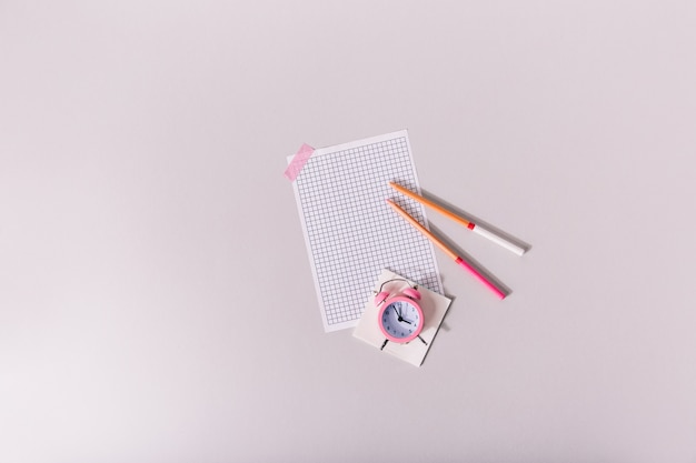 Blank sheet of paper glued with pink tape to table