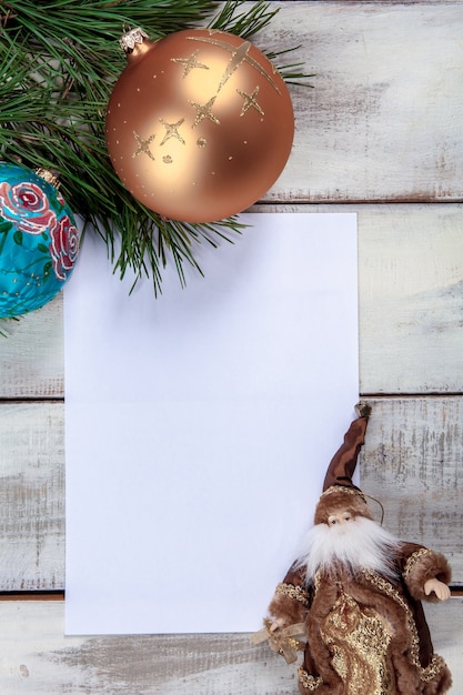 Free Photo the blank sheet of paper on the wooden table with christmas decorations.