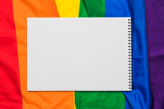 Blank spiral notebook on rainbow flag