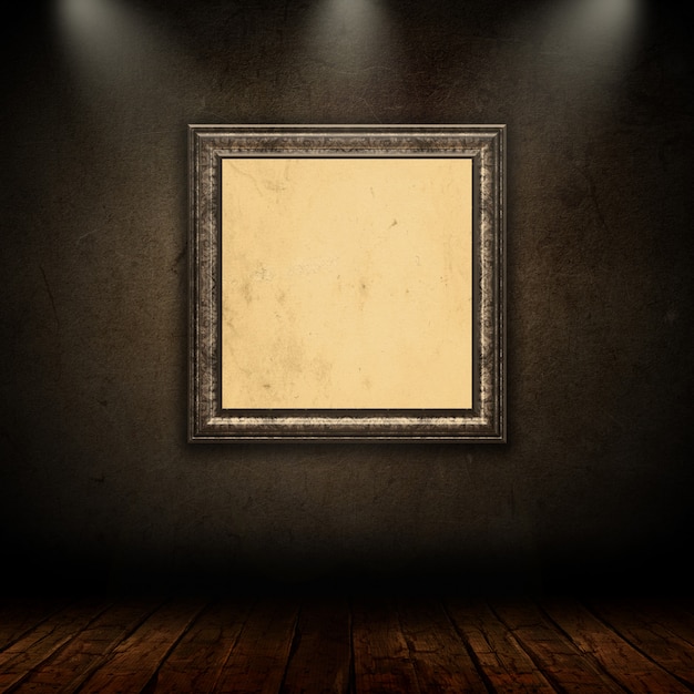  blank vintage picture frame in grunge room with spotlights