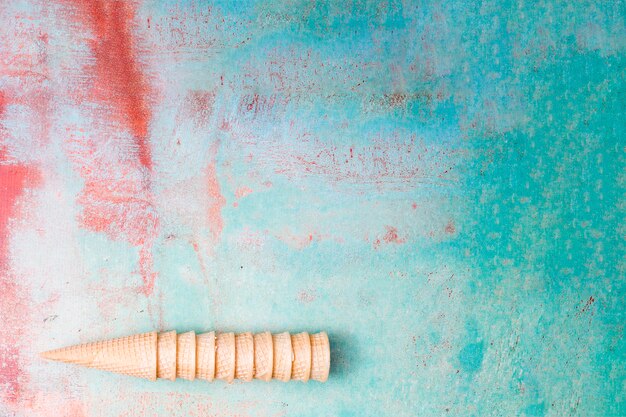 Blank wafers ice cream cones gathering into each other on multicolored background