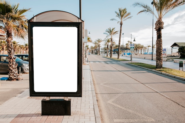 Blank white bus stop box in sunlight