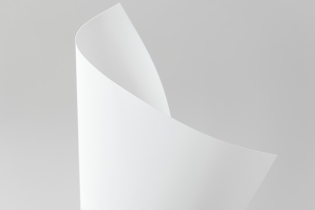 Blank white folded paper on a gray background