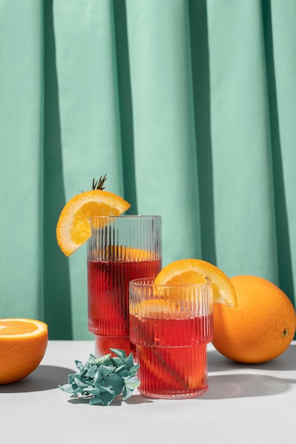 Free photo blend of cocktails in glasses with orange fruit