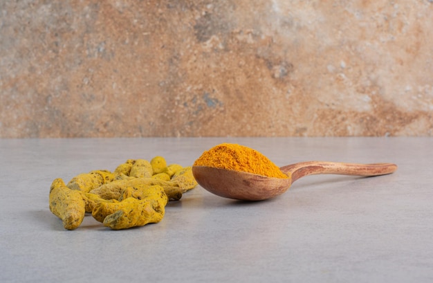 Blended curcumin powder in a wooden spoon. 