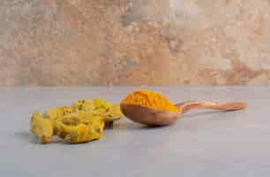 Free photo blended curcumin powder in a wooden spoon.