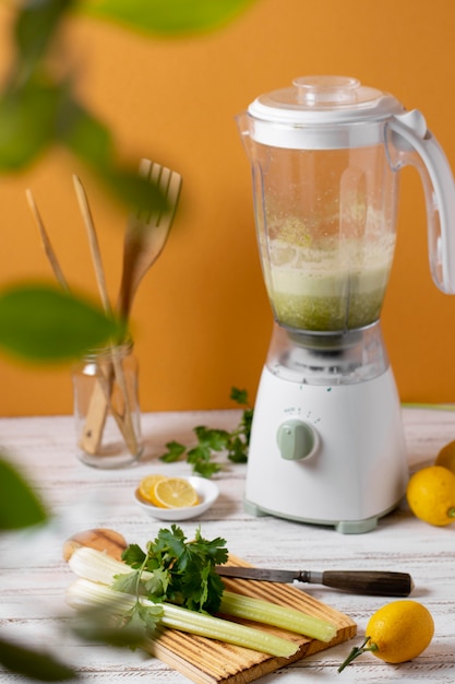 Free photo blender and celery arrangement