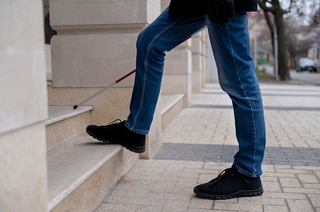 Blind man walking using his walking stick