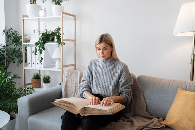 Blind person reading at home