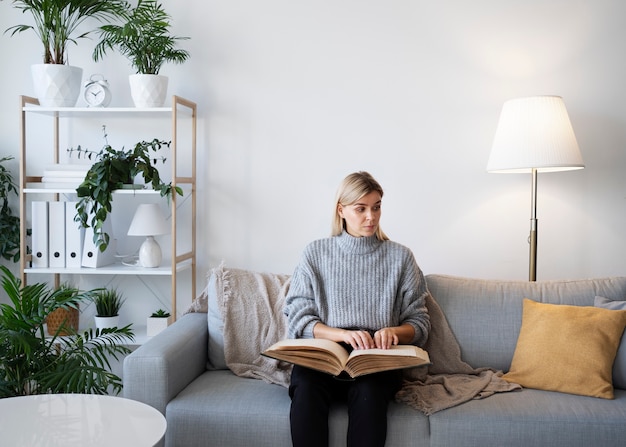 Blind person reading at home