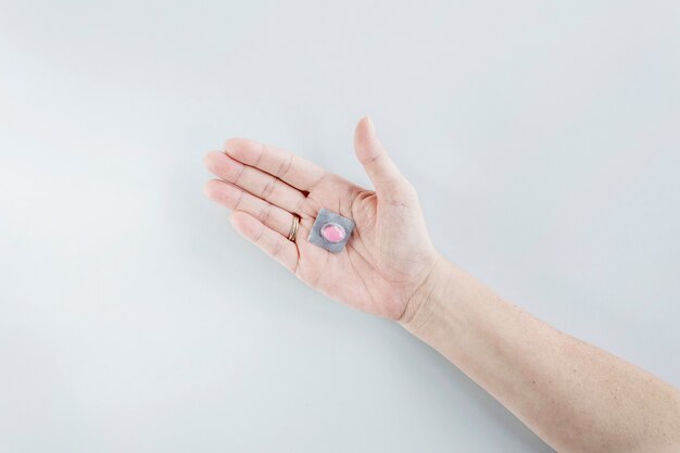 Free photo blister pack of single pill on person's hand