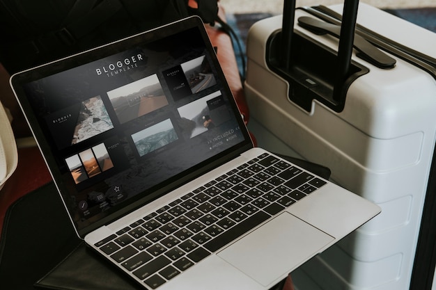 Free photo blogger laptop by a luggage at the airport